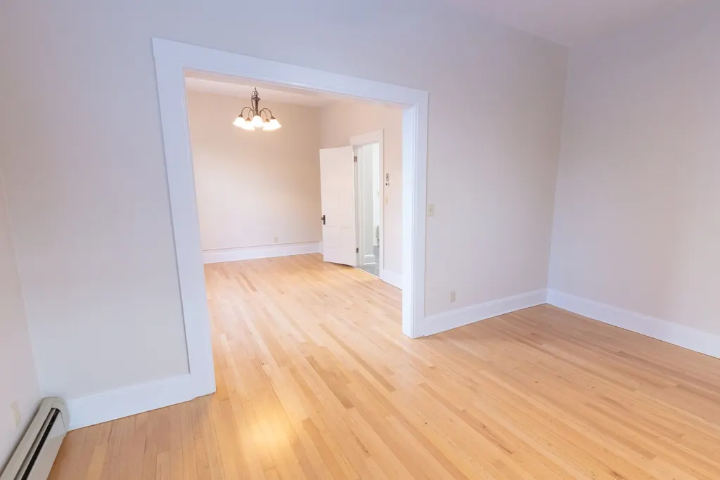 Empty living room with light oak-effect laminate flooring