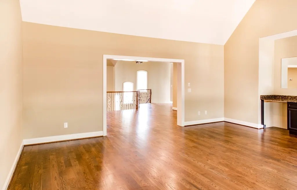 Empty room with polished solid wood strip flooring